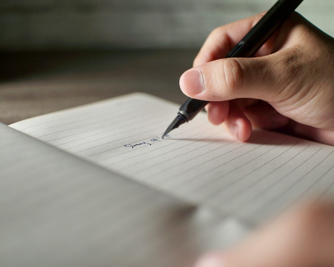 person writing in journal