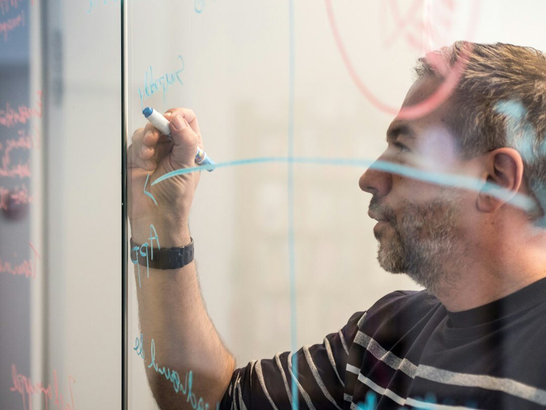 man planning goals on whiteboard